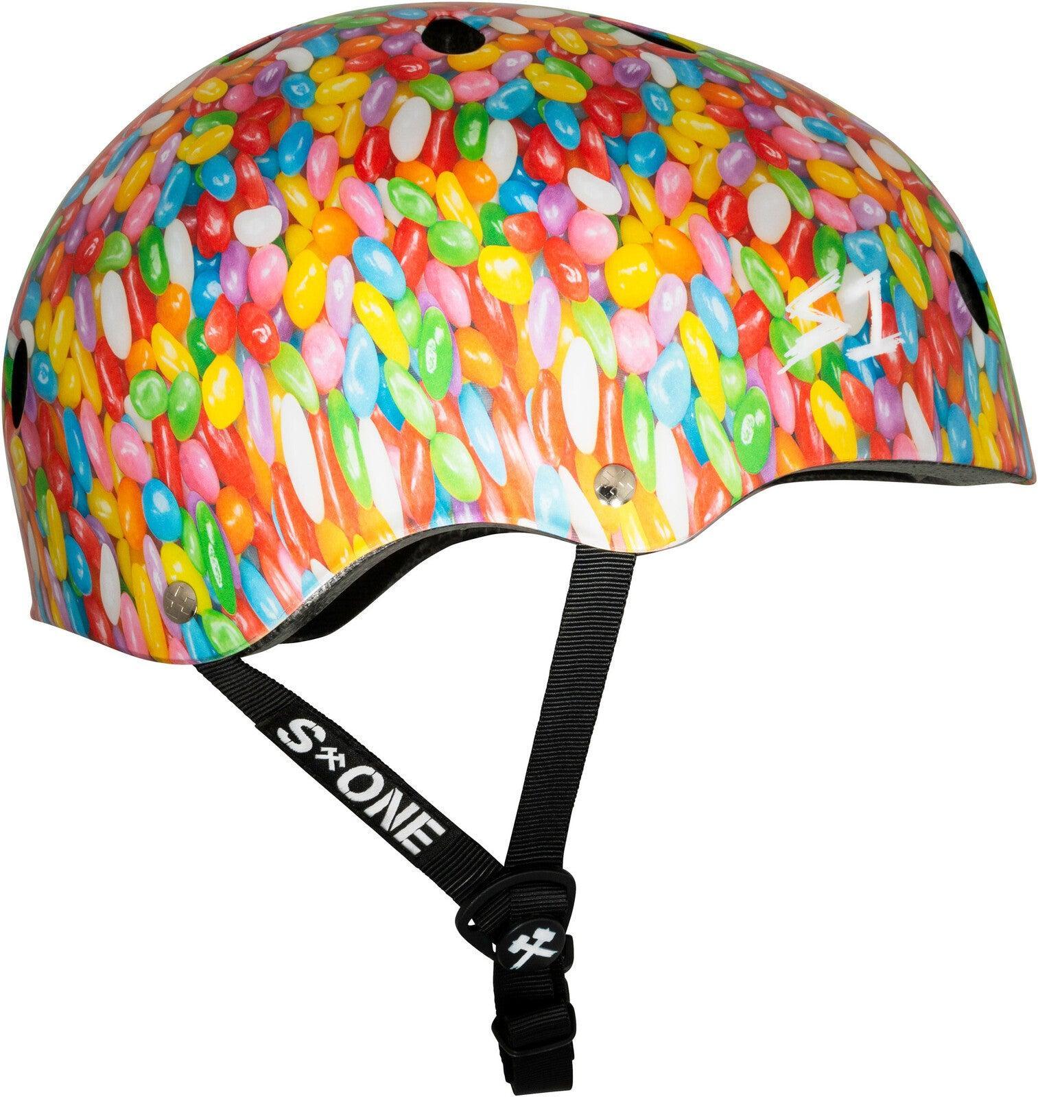 The S-One Lifer Helmet / Jelly Beans is a certified skateboard helmet with a vibrant jelly bean pattern, black adjustable straps, multi-impact protection, and the S1 logo on the side and strap.