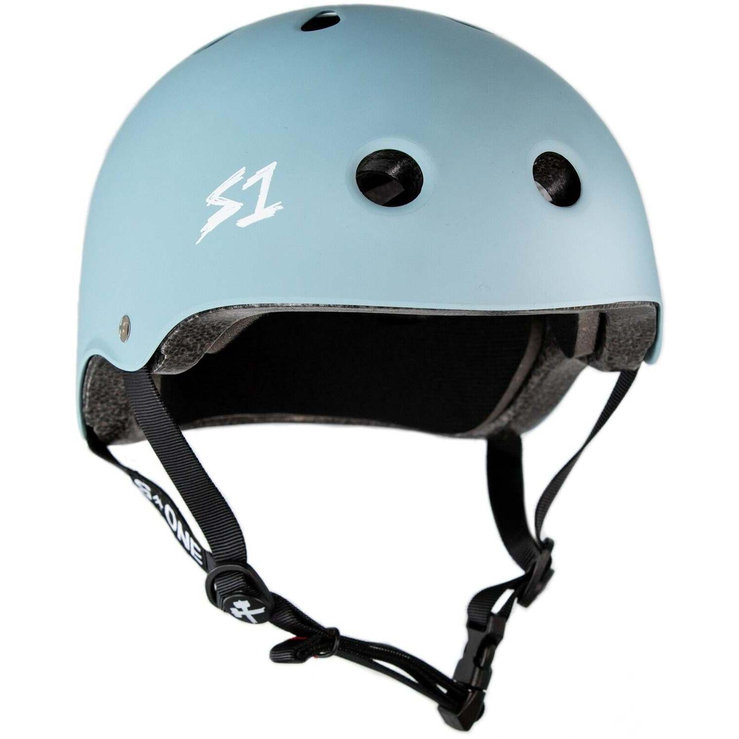 Slate Blue Matte S-One Lifer Helmet features black foam lining, multiple ventilation holes, adjustable black straps, and a white "S1" logo on the front. Engineered for multi-impact protection.