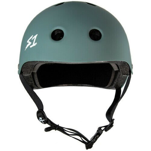 The S-One Helmet Lifer features a matte green finish with vent holes, a black foam interior, adjustable chin strap, and a white "S1" logo, delivering certified multi-impact protection for skaters.