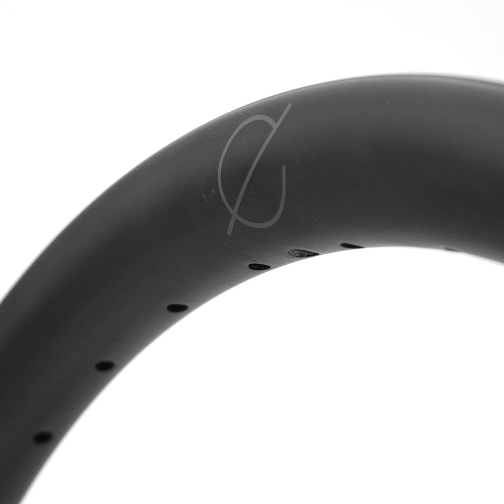 A close up of a Spectre Carbon Fibre 451x23mm Braking Rim known for its reliability and backed by an extensive warranty.