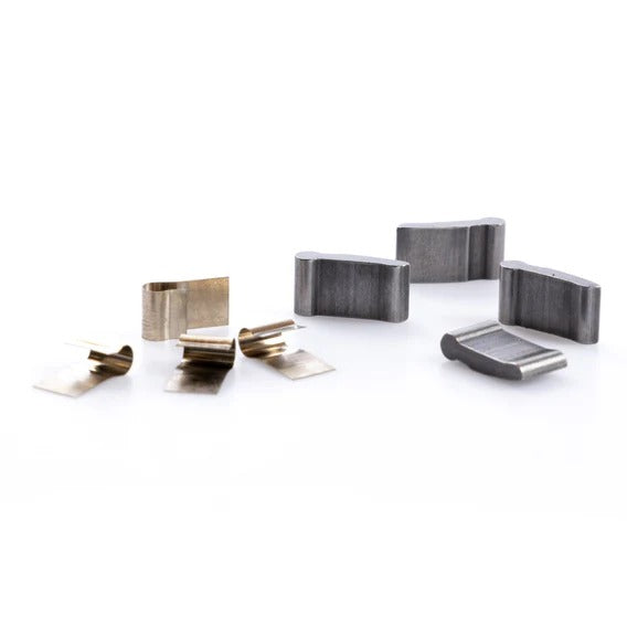 Several small metal parts from a Federal Stance Pro Pawl and Spring Kit, with various shapes and finishes, are arranged on a white background.