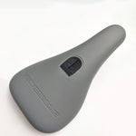 The Stay Strong Cut Off Slim Pivotal Seat is a gray seat made with microfibre material, featuring a logo and stitched emblem on top.