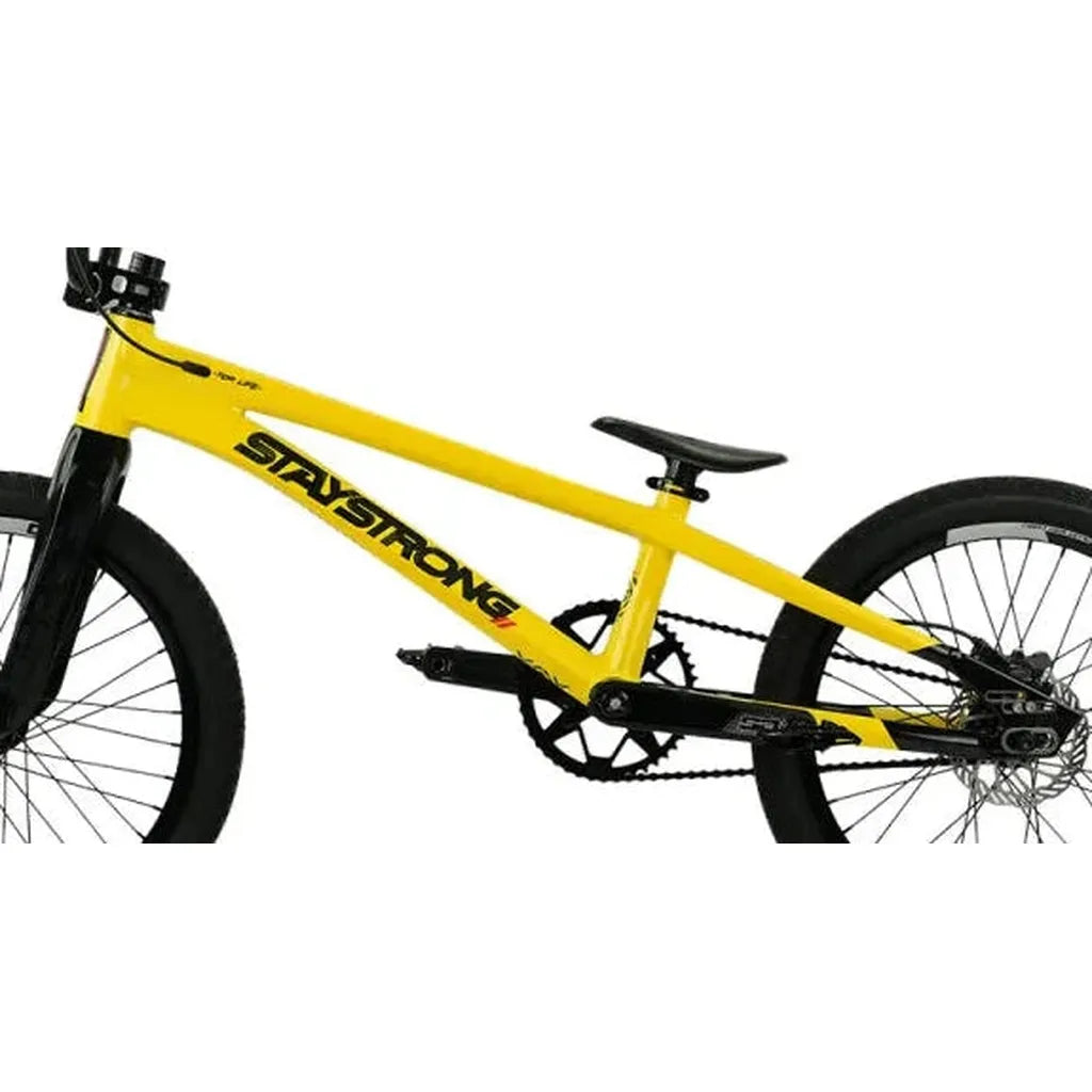 A yellow Staystrong V5.1 Pro XXL Disc Frame BMX bike with black handlebars, wheels, and seat is displayed on a plain white background. Featuring a BMX race frame with advanced race geometry for optimal performance, the frame displays "STAY STRONG" printed in black letters, highlighting the Staystrong V5.1 Pro XXL Disc model.