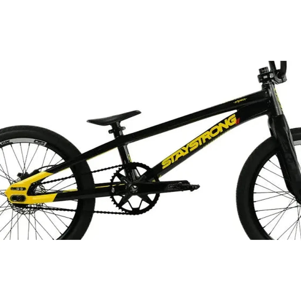 A black Staystrong V5.1 Pro XXL Disc BMX race frame with yellow accents and “Stay Strong” written on the frame is shown from the side on a white background, featuring race geometry.