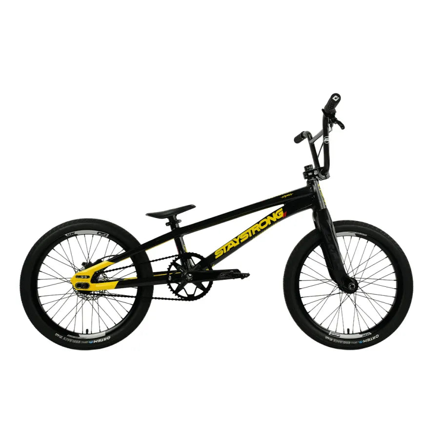 A black Staystrong V5.1 Pro XXL Disc BMX race frame with yellow accents and “Stay Strong” written on the frame is shown from the side on a white background, featuring race geometry.