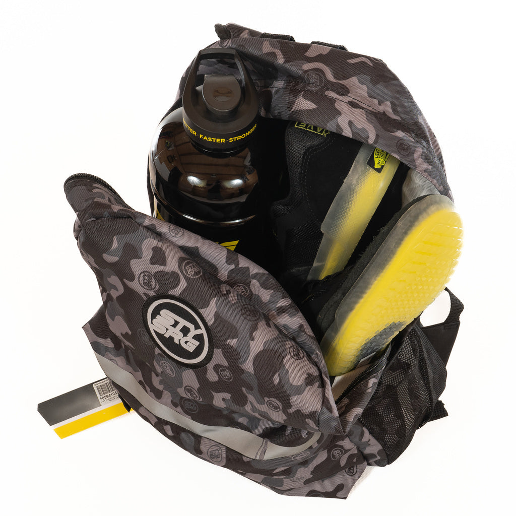 Open Staystrong Backpack Chevron V3 in camo, featuring adjustable shoulder straps, containing a black and yellow water bottle, a pair of black sneakers with yellow soles, and a partially visible yellow and black item against a white background.
