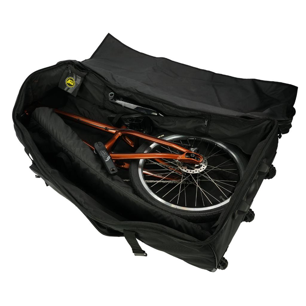 A partially disassembled bicycle with an orange frame is packed in a Staystrong V4 Bike Bag, with the wheels and frame securely positioned inside the black travel bag.