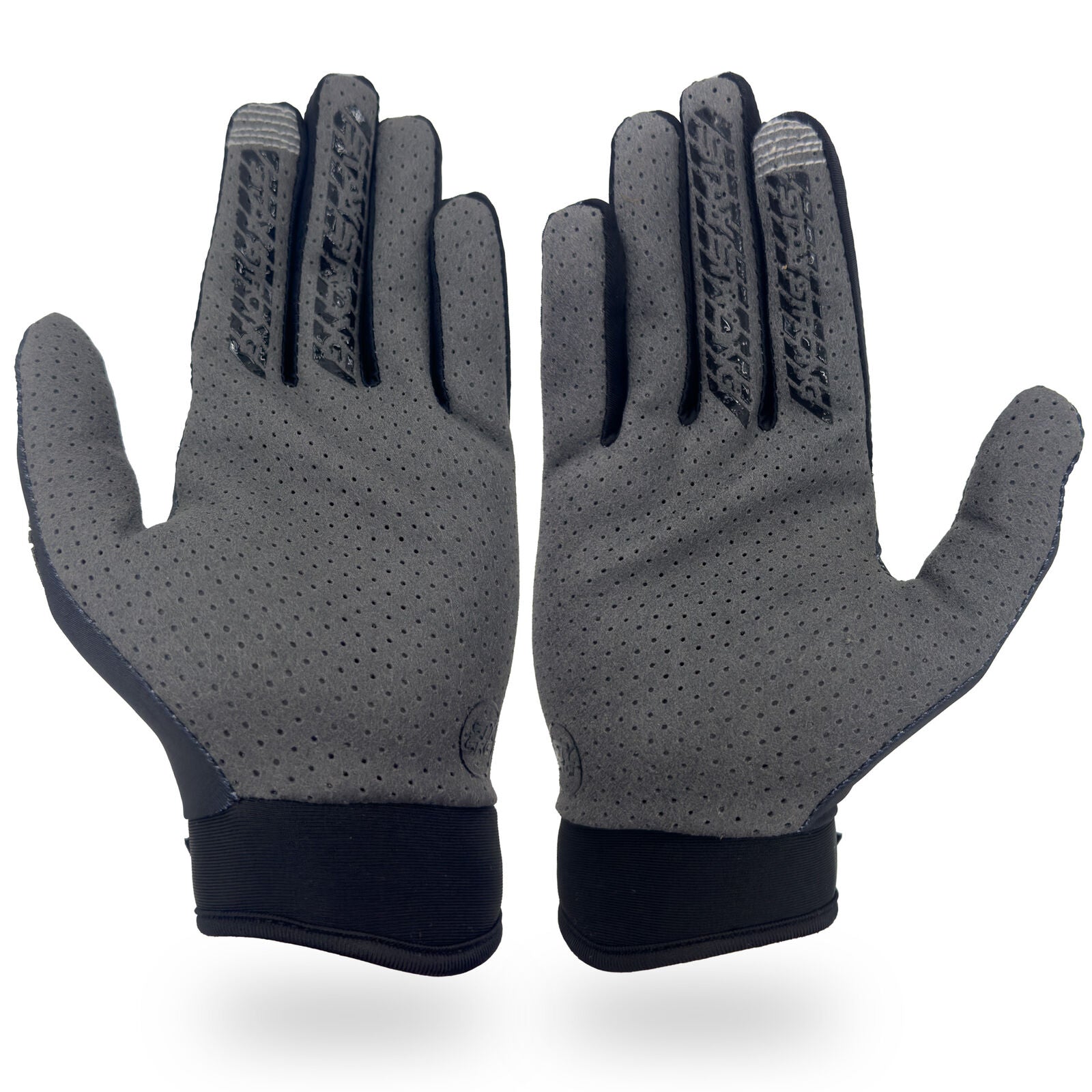 A pair of Staystrong Glove MAB Max Cairns Black, featuring gray perforated palms and black cuffs, displayed palm side up on a white background.