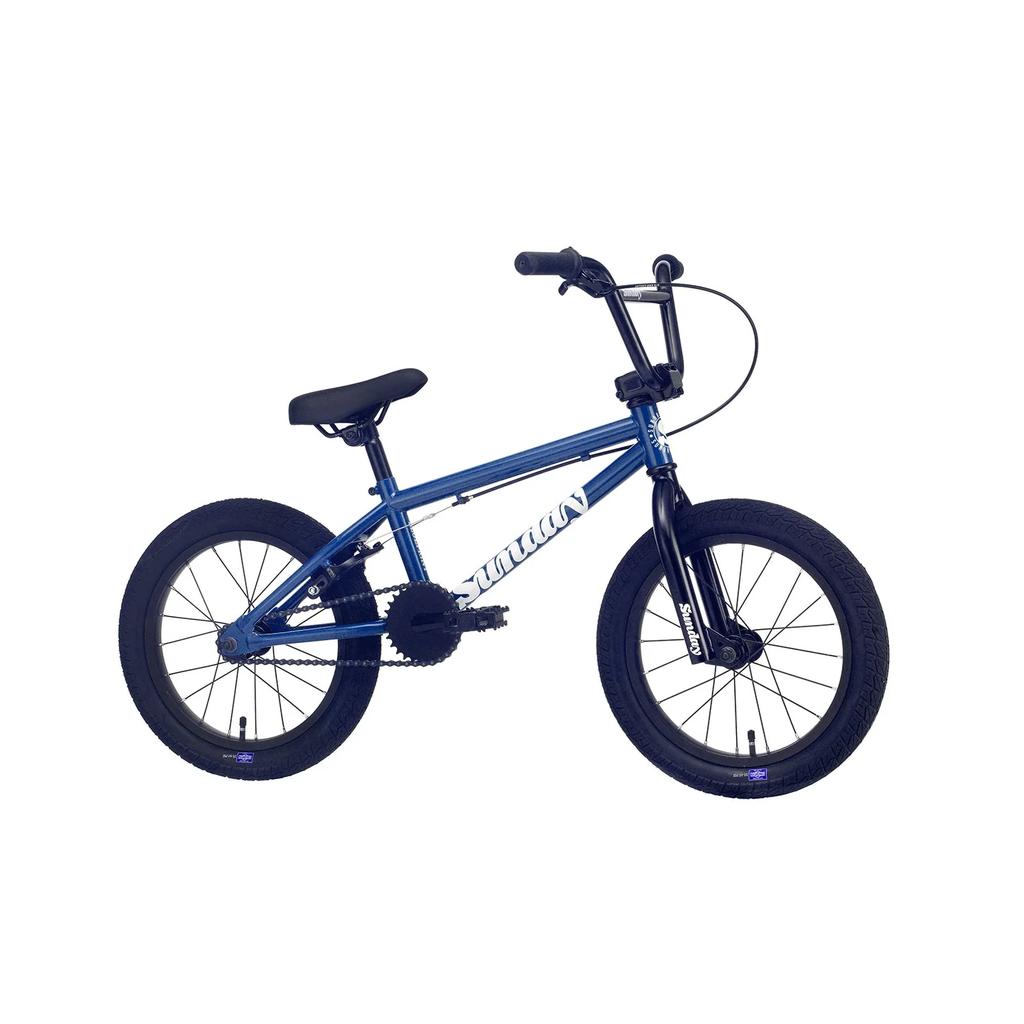 The Sunday Blueprint 16 Inch Bike, featuring a small blue and black frame, thick tires, straight handlebars, Odyssey Springfield Brakes, and a padded seat, is displayed against a white background.