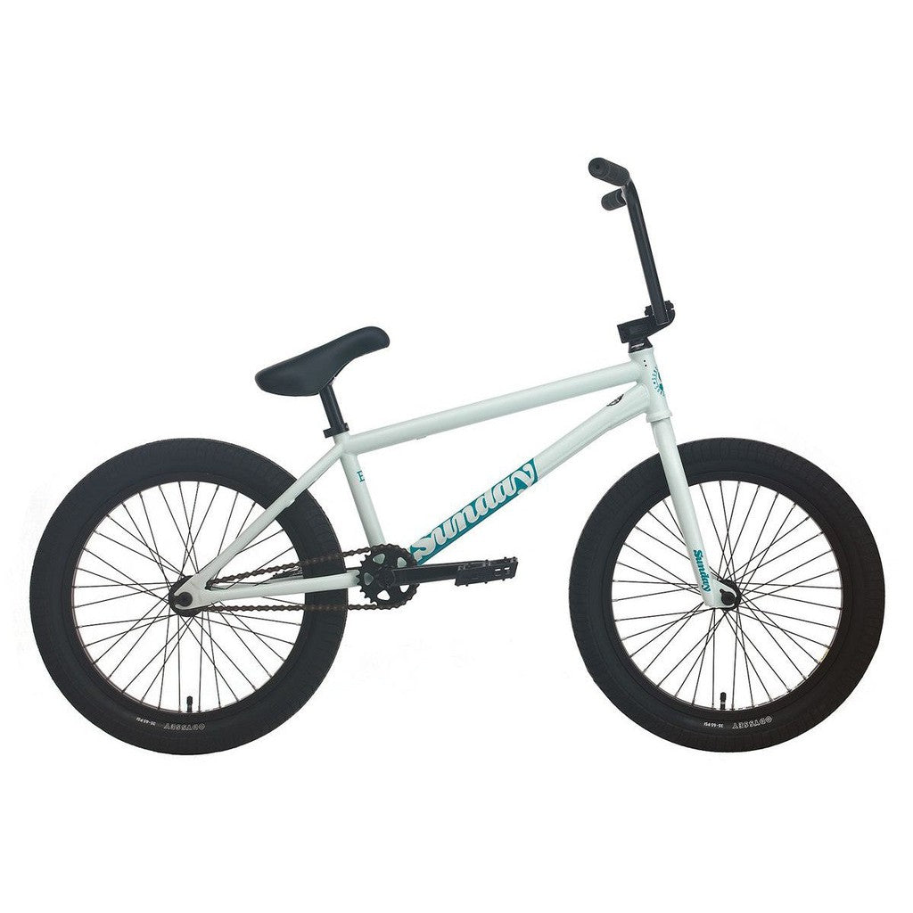 The Sunday EX Julian Arteaga 20 Inch Bike is shown in profile with a white frame, black tires, pedals, and handlebars. This signature model features a 100% chromoly frame for enhanced durability and style against a plain white background.