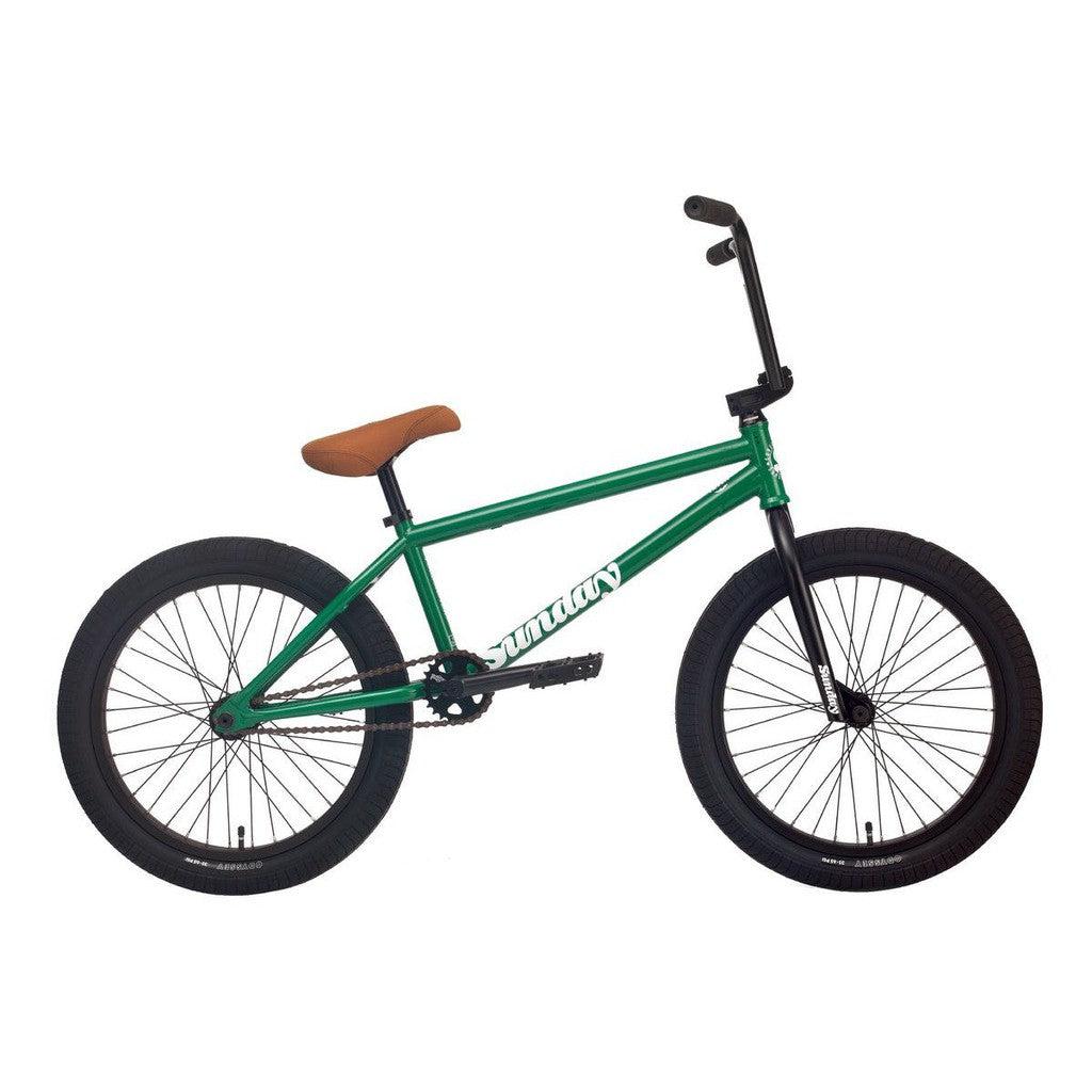 The Sunday Forecaster 20 Inch Bike (2022) / Alec Siemon features a green frame with a tan seat, black tires, and handlebars. Its 100% chromoly build prominently displays the "Sunday" brand name. This model also includes the Odyssey Clutch v2 Freecoaster for smooth riding.