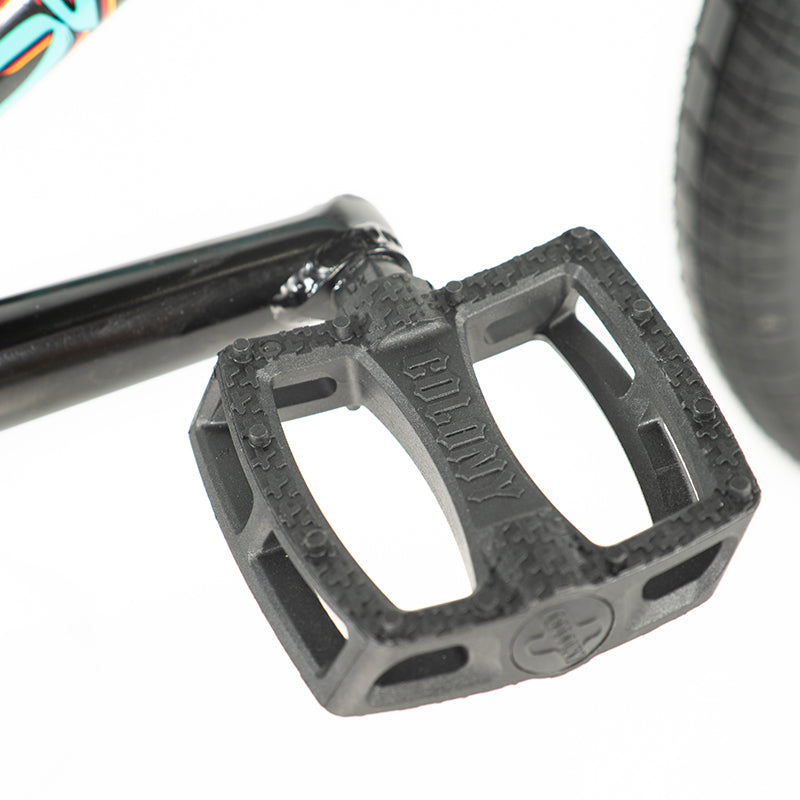 A close up of a high end black pedal on a Colony Sweet Tooth Pro 18 Inch BMX bike.