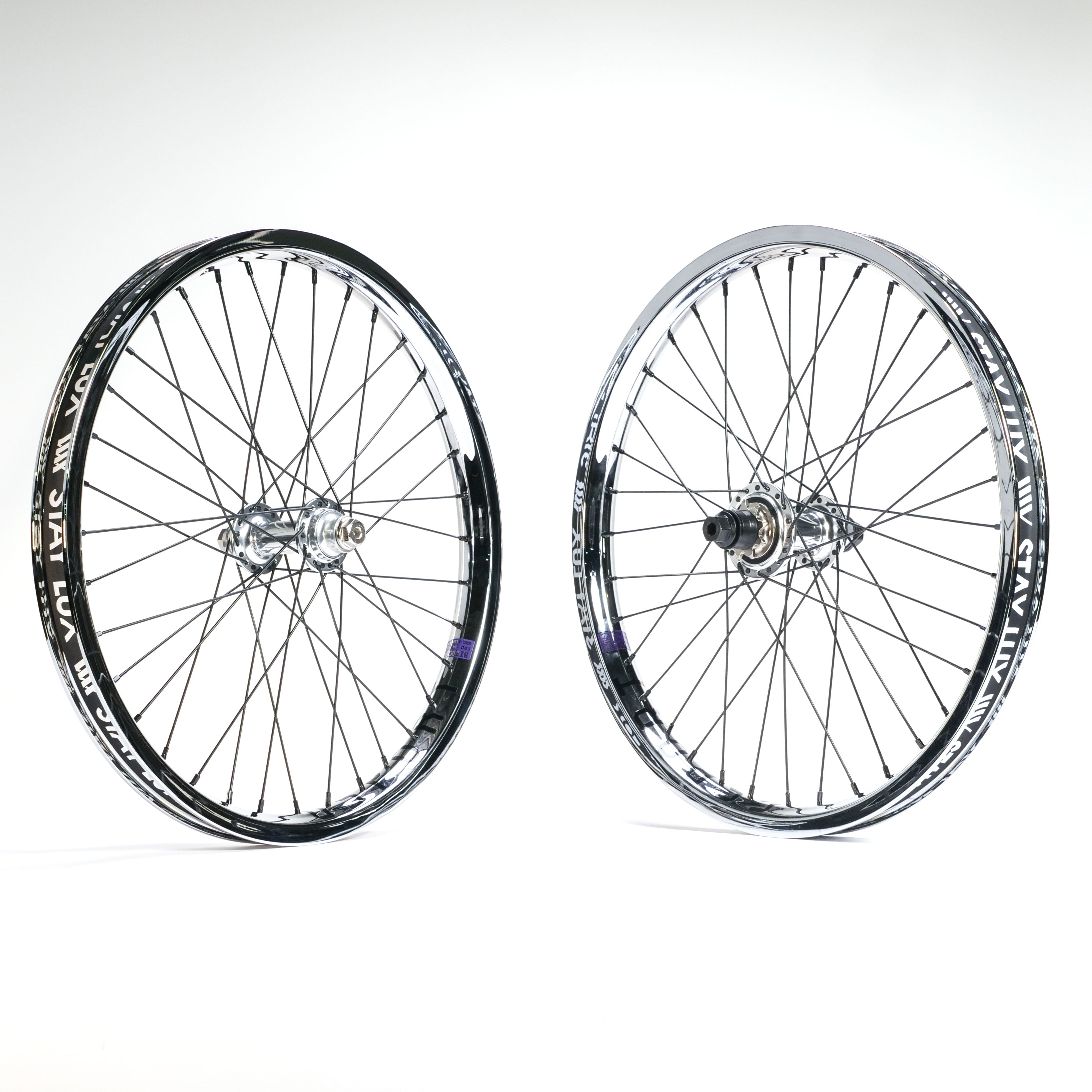 The Tall Order X Birdcage Custom Wheelset features two black and silver BMX wheels with GSport Birdcage rims, displayed upright on a white background—one shows the front hub, the other reveals the rear hub with gear cassette.