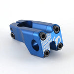 A blue Tangent Front Load Stem, featuring multiple bolts and bearing the proud "TANGENT" inscription on its precisely CNC-manufactured surface, epitomizes race products.