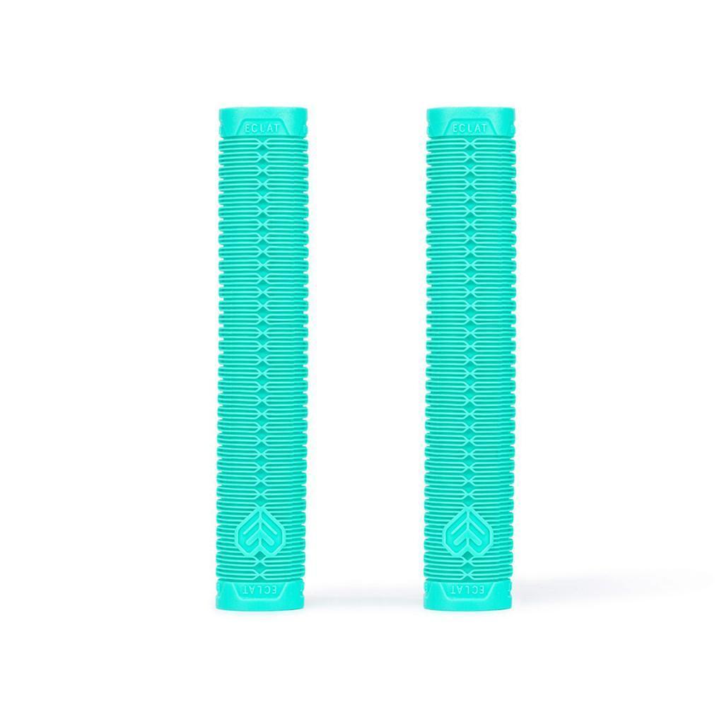 Two Eclat Shogun Grips in turquoise, featuring textured VEX20 rubber and branding on each end, are standing upright side by side on a white background.