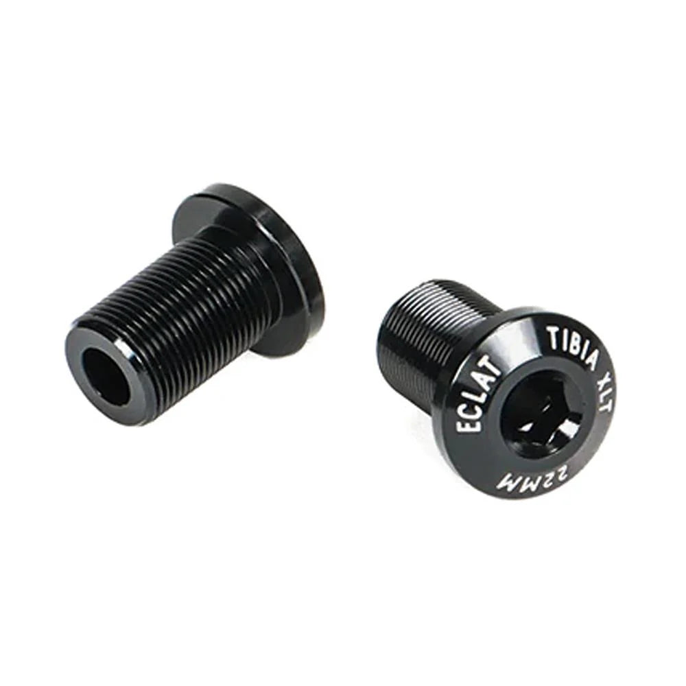 Two black alloy threaded bolts with hexagonal sockets, labeled “Eclat Tibia XLT Crank Spindle Bolt” in white on the heads, shown on a white background—ideal as a replacement bolt for Tibia XLT cranks.