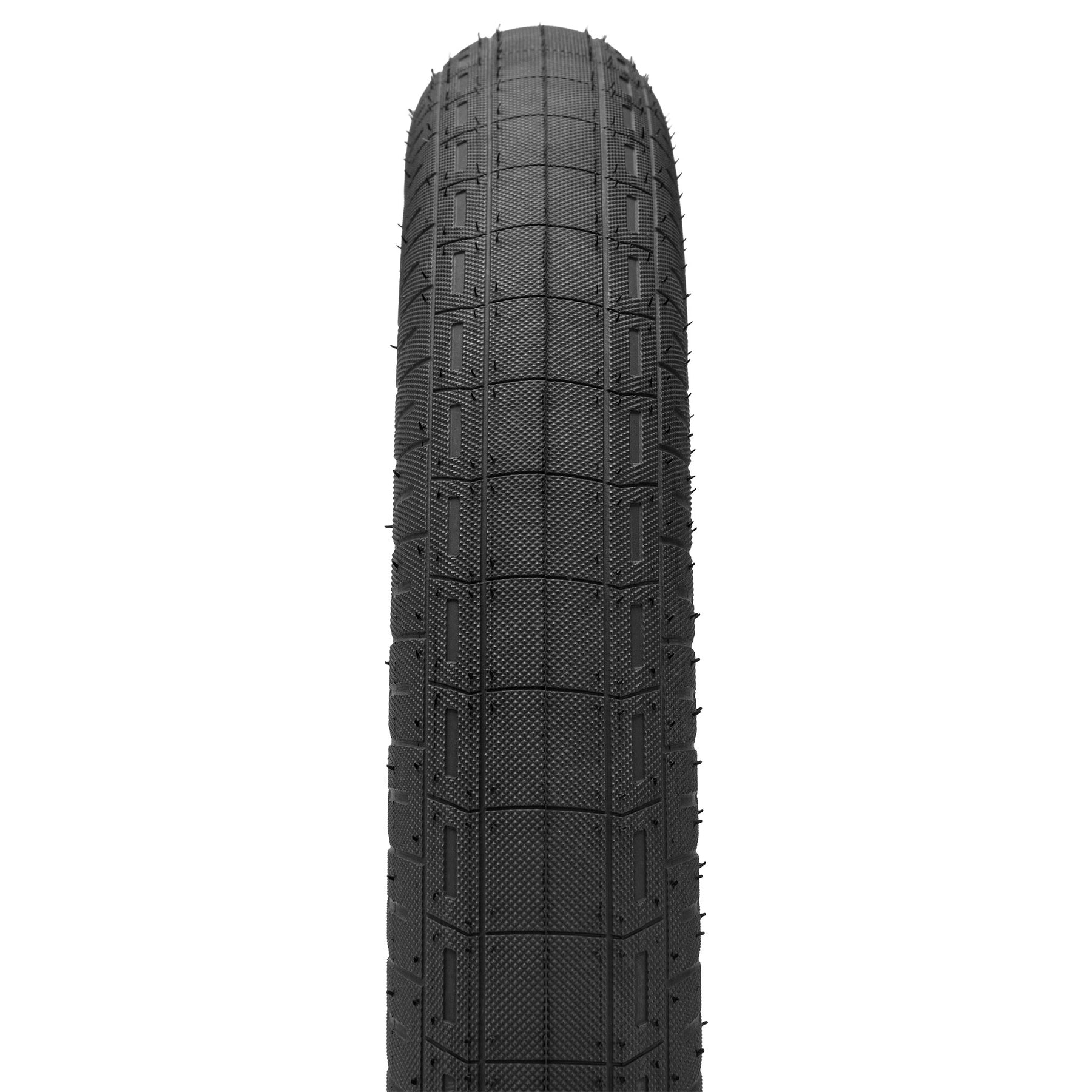 Close-up view of the Kink Wake 20 Inch Tyre, a black BMX tire featuring a grippy, grid-like tread, photographed from above on a white background.