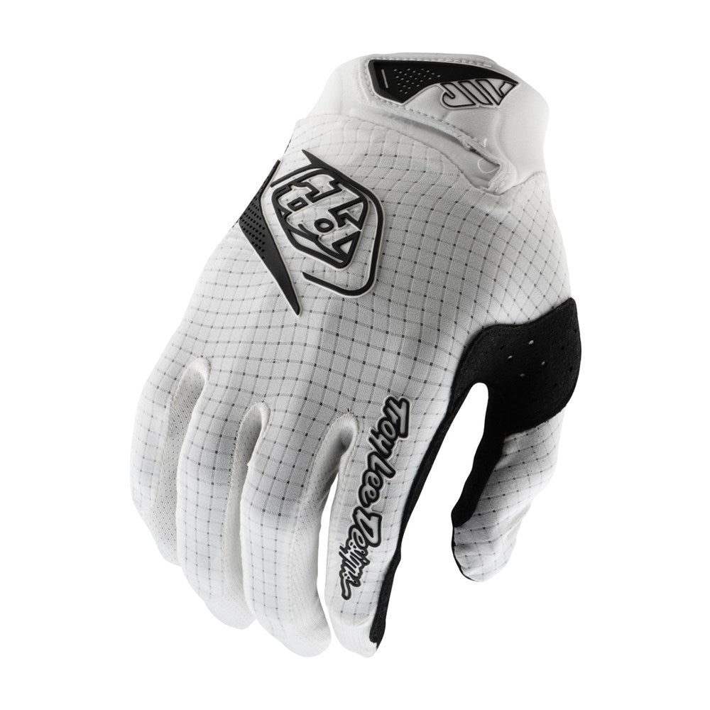 The TLD 25.1 Air Glove Mono White features micro-mesh ventilation in a white and black design, with a logo on the back and "Troy Lee Designs" elegantly inscribed on the wrist.
