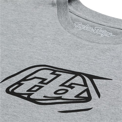 Close-up of a gray TLD 25.1 Badge SS T-Shirt featuring a black Banger geometric design with stylized letters.