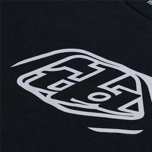 Close-up of the TLD 25.1 Badge SS T-Shirt in black, showcasing a stylized white graphic with angular and curved lines, reminiscent of iconic Troy Lee designs.