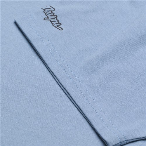 Close-up of a TLD 25.1 Peace Out T-Shirt in light blue, featuring a folded corner and a small embroidered logo in the top left for good vibes.