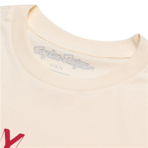 Close-up of a cream-colored TLD 25.1 Rotation SS T-Shirt collar with the "Troy Lee Designs" logo on the inner label, ideal for daily wear. A red graphic peeks from the left, exuding a good life vibe.