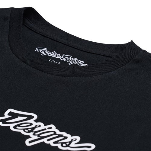 The TLD 25.1 Signature LS Shirt is a black long sleeve featuring white script "Designs" on the front and "Troy Lee Designs L.L./L" inside the collar, offering comfort and iconic style for winter wear.