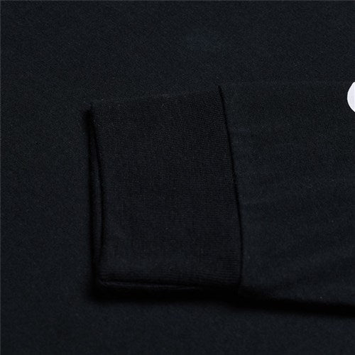 Close-up of the TLD 25.1 Signature LS Shirt in black with a folded cuff on a dark background, ideal for winter layering.