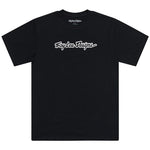The TLD 25.1 Signature SS T-Shirt features "Troy Lee Designs" in white cursive across a black backdrop, epitomizing the brand's iconic style. This standout tee is a must-have for any fashion-forward wardrobe.