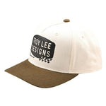 The TLD 25.1 Stamp Curved Hat in beige and brown is perfect for everyday wear, showcasing "Troy Lee Designs" on the front.