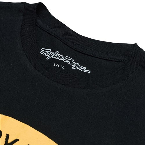 Close-up of the TLD 25.1 Stamp SS T-Shirt, showing a stylish black tee adorned with a striking yellow graphic, labeled inside as "TLD Pride: Taylee Designs L/L/L.