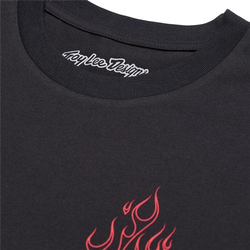 The TLD 25.1 Torched LS Shirt is a black tee from Troy Lee, showcasing "Troy Lee Designs" on the collar and a bold red flame graphic across the chest.