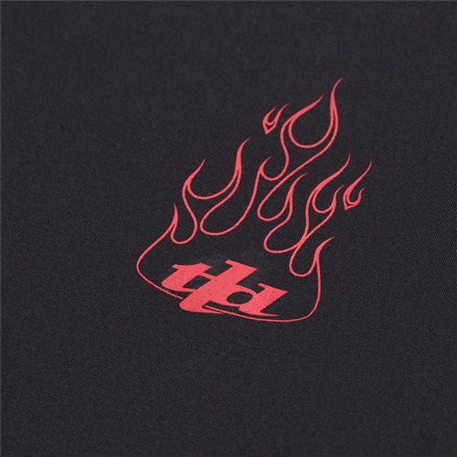 The TLD 25.1 Torched LS Shirt is a black fabric shirt with a red flame graphic above the "tb1" letters, embodying the spirit of Troy Lee's legendary brand.