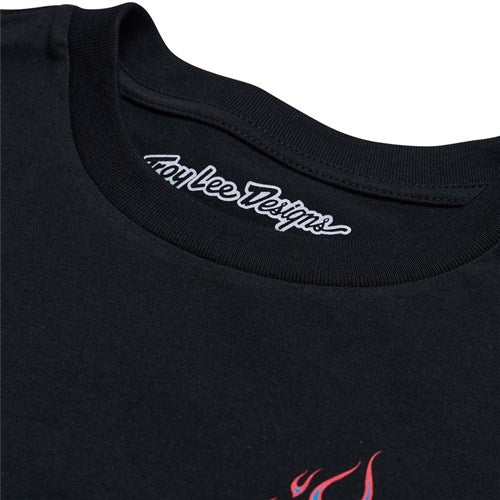 The black TLD 25.1 Torched SS T-Shirt features "Troy Lee Designs" on the inner collar and a bold partial red graphic on the front, making it a statement piece.