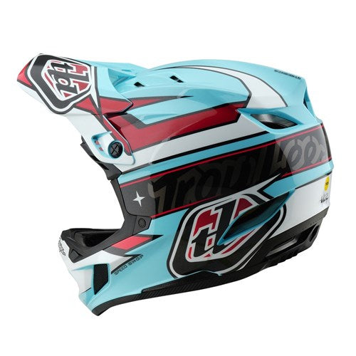 The TLD D4 Polyacrylite Helmet (MIPS) / Linear Blue is a striking full-face helmet in blue, red, and white with geometric patterns, a visor, and crafted from durable Polyacrylite. It features the Troy Lee Designs logo and incorporates Mips® C2 technology for enhanced protection.