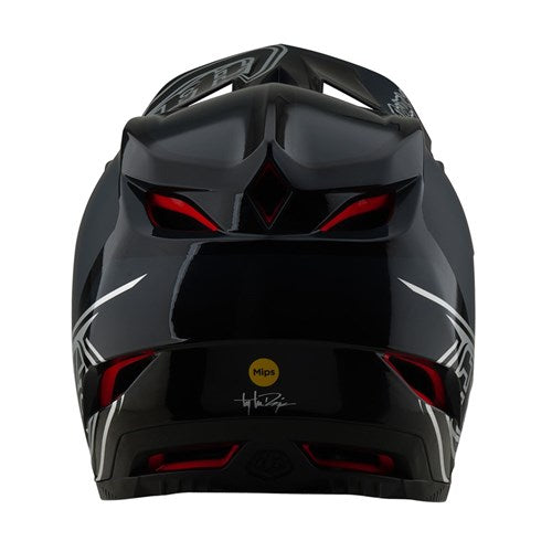 The TLD D4 Polyacrylite Helmet in Shadow Black features a sleek, aerodynamic design with bold red accents. Its Polyacrylite shell integrates the Mips® C2 brain protection system, highlighted by the prominent MIPS logo and signature at the rear.