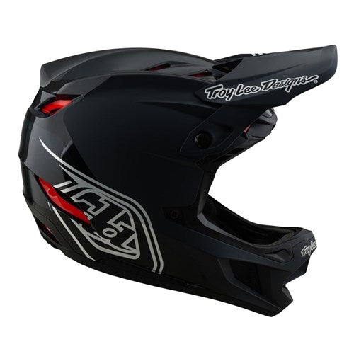 The TLD D4 Polyacrylite Helmet (MIPS) in Shadow Black is a full-face helmet with a Polyacrylite shell, featuring a visor, side graphic design, and the Troy Lee Designs logo.