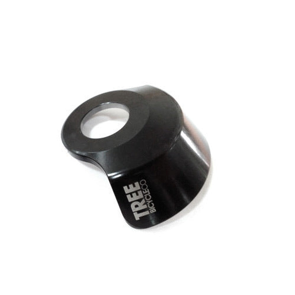 The Tree Bicycle Co DS Hub Guard is a black metal bike part featuring a circular opening and "TREE BICYCLE CO" text on the side. This Chro-Mo hub guard enhances durability, fitting most hubs for seamless integration with your ride.