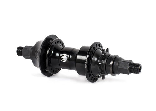 Shadow Symbol Cassette Hub BMX rear hub with spoke flange holes, threaded axle ends, central manufacturer logo, and plastic hub guard, isolated on a white background.