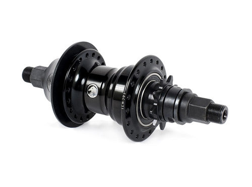 The Shadow Optimized Freecoaster Hub is a black BMX hub featuring multiple spoke holes, dual axle bolts, a visible bearing system, and is compatible with a plastic hub guard.