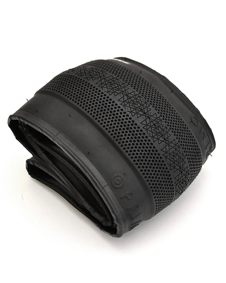 A Primo Richter 20 Inch Folding Tyre in black, sized 20x2.4 with a patterned tread and smooth sidewalls, is displayed on a white background, showcasing its lightweight folding tire design.