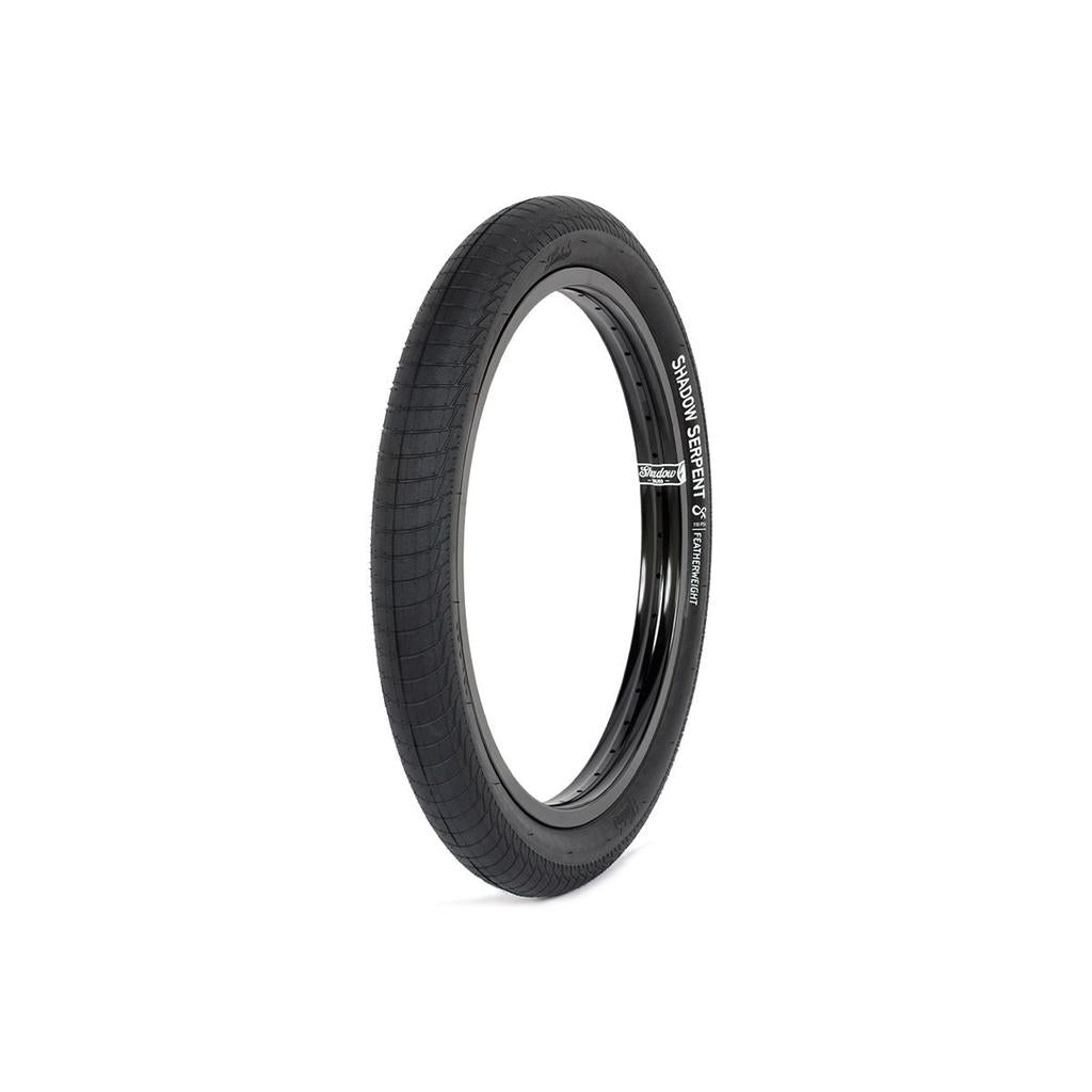 The Shadow Serpent Tyre is a black BMX park tire with patterned tread for high grip, featuring white "SIMON STEVENS 18" text on the sidewall and mounted on a black rim, shown against a white background.