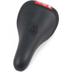 The Shadow Crow'd Pivotal Seat is a black bike seat with a textured synthetic leather surface and a red label on the back featuring white text.