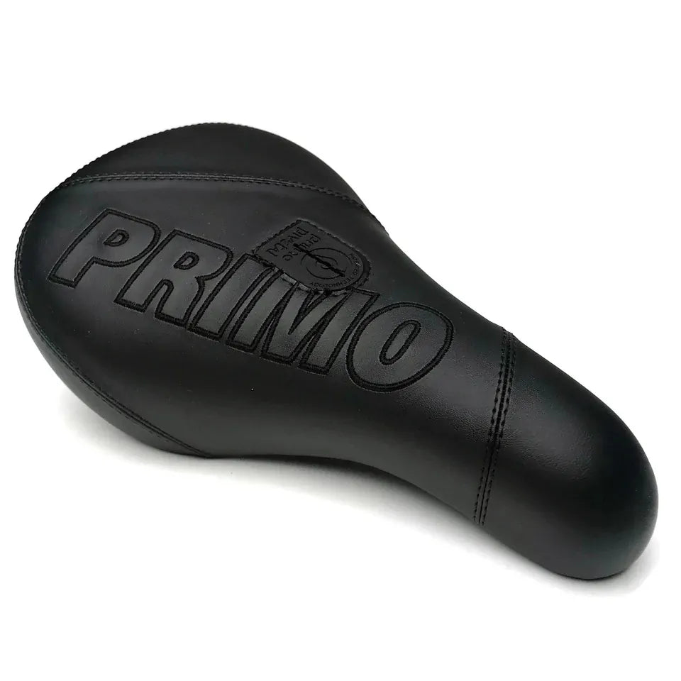 The Primo Breaker Pivotal Seat is a black BMX seat with “PRIMO” embossed on top, showcasing visible stitching and a textured leather-like surface. This fat pivotal seat is designed for style and comfort, offering a durable option for your bike.