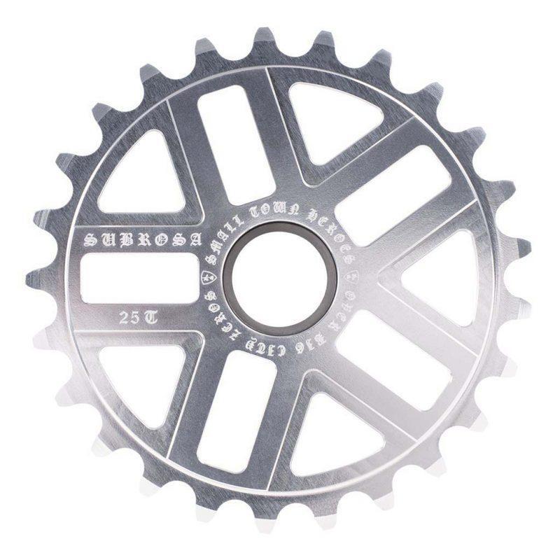 The Subrosa Hero Sprocket is a silver metal sprocket with 25 teeth, featuring "Subrosa" branding and etched text around the center hole—a stylish bike accessory for any BMX setup.
