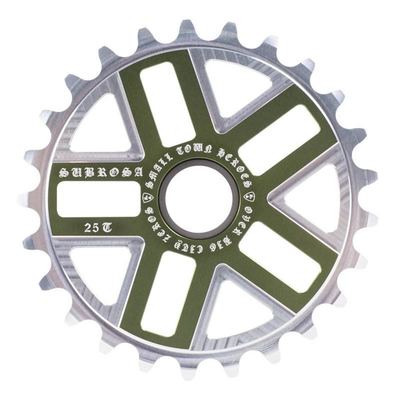 The Subrosa Hero Sprocket is a stylish BMX accessory in silver and olive green, featuring "SUBROSA 25T" and "Small Town Rebels" engraved on the sprocket.