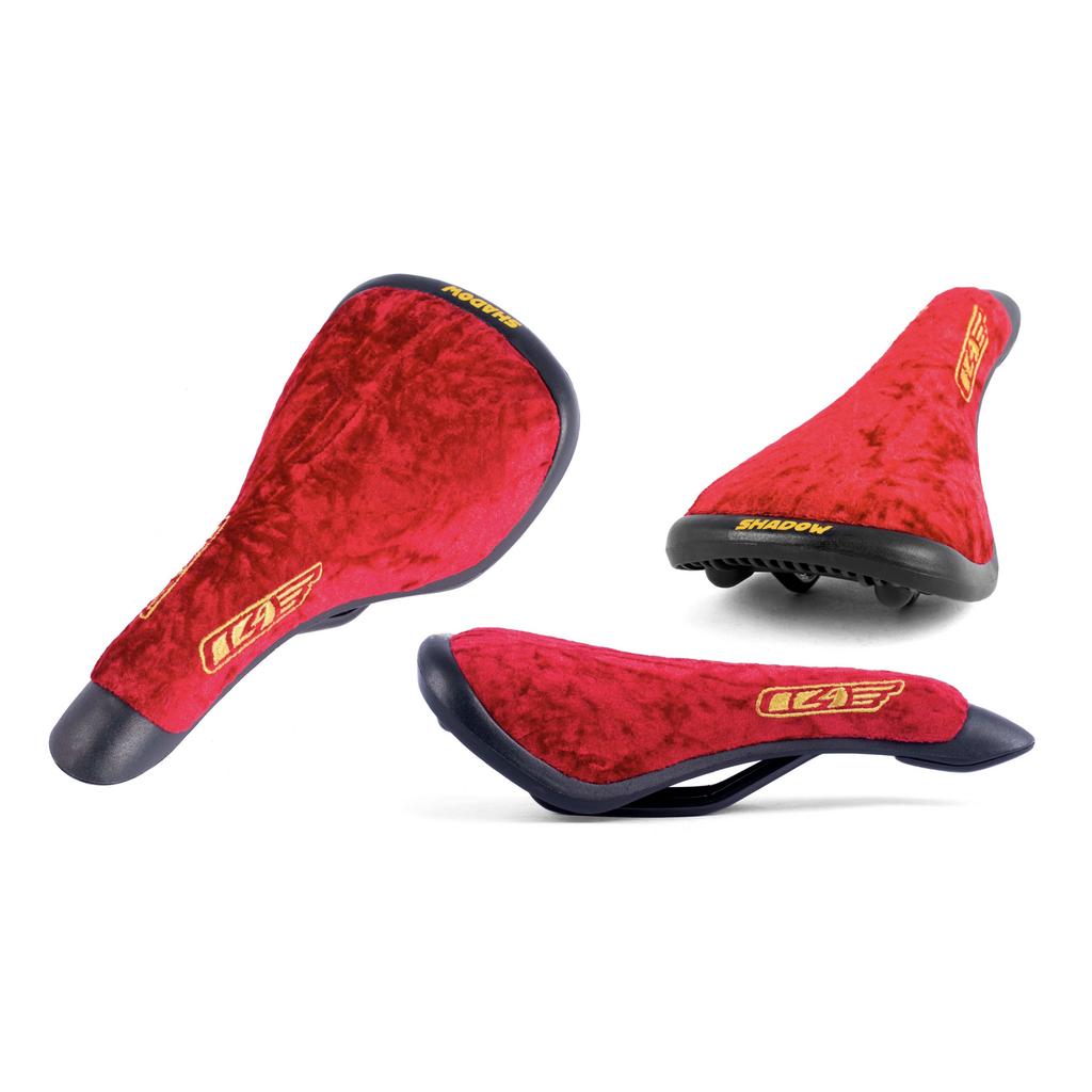 The Shadow Penumbra Railed Seat, Trey Jones S11 Signature, features three views with sleek black accents and bold yellow branding on the back and side. This red velvet bike saddle is perfect for those who value both style and performance.