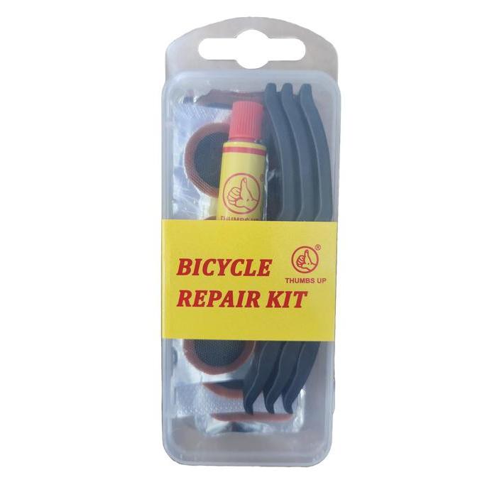 The Tube Repair Kit, adorned with the "Thumbs Up" logo, includes tire levers, adhesive, and essential patches for quick fixes.