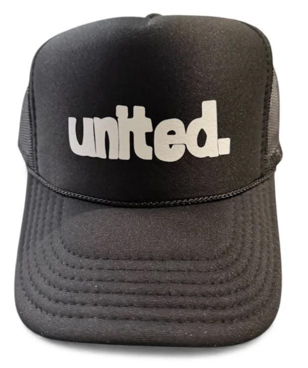 The United Coastin Trucker Hat is a black hat featuring "united." printed in bold white letters on the front.