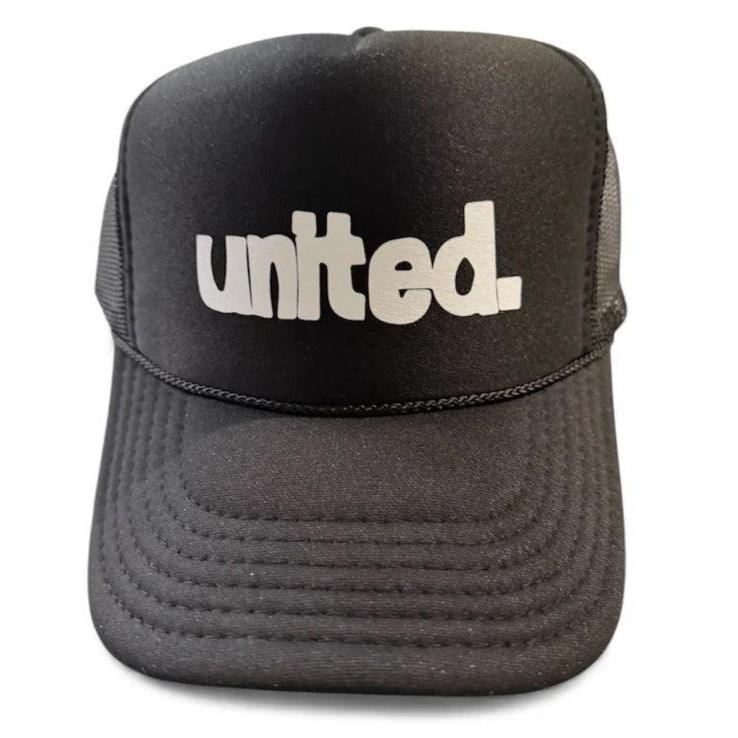 The United Coastin Trucker Hat is a black hat featuring "united." printed in bold white letters on the front.
